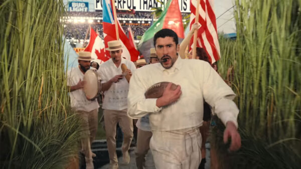 A flag of Canada is waved behind Bad Bunny during his Super Bowl halftime performance.
