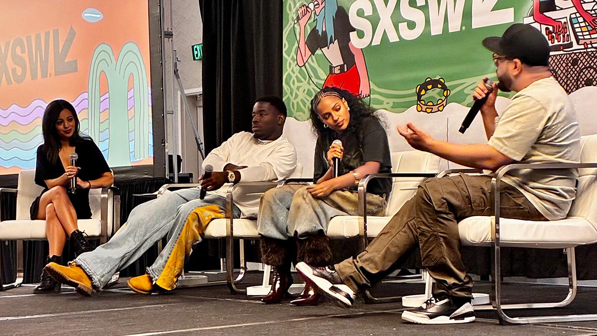 3 panelists and a host on stage at a SXSW event.