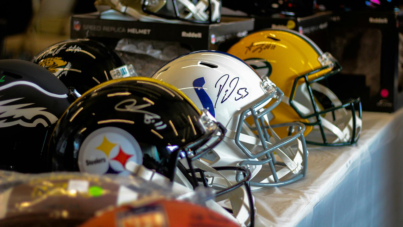 Autographed NFL helmets on display.