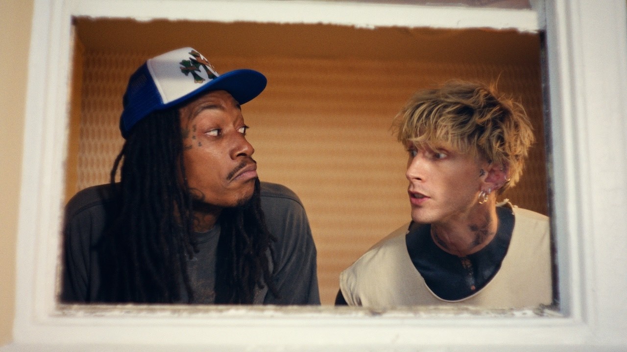 Wiz Khalifa and mgk look at each other in a scene from their collaborative music video, girl next door.