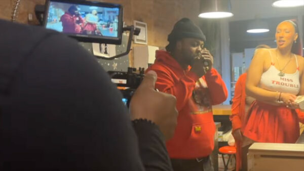 Price Da Boss lights a smoke in a scene from The Man Again music video.