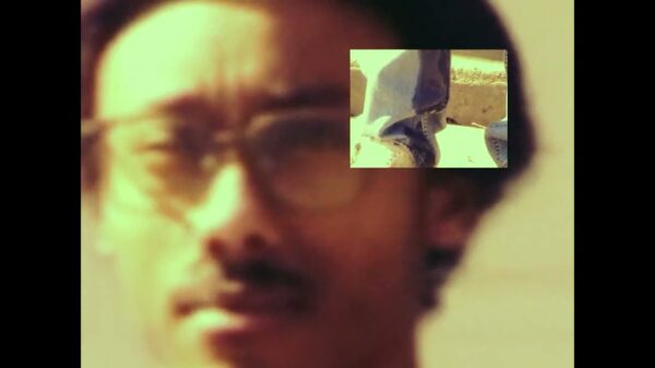 student 1 looks at the camera in a scene from his pissing myself music video.