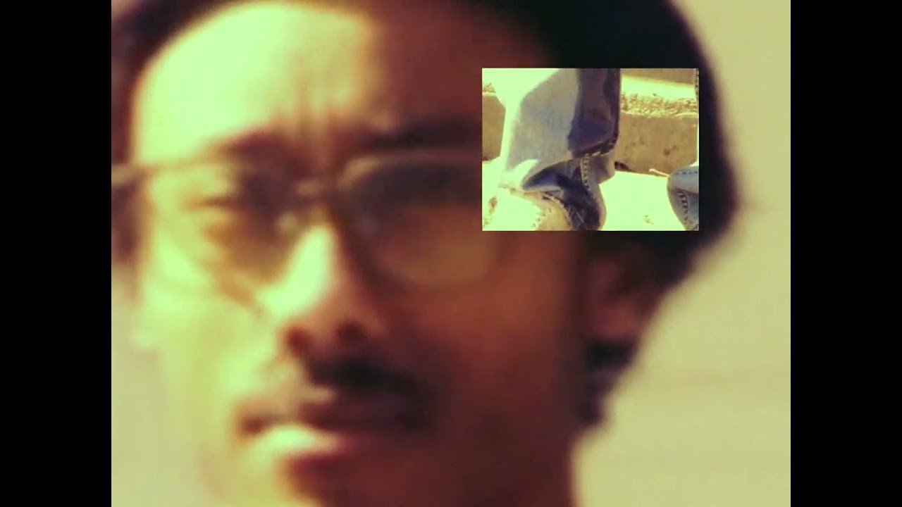 student 1 looks at the camera in a scene from his pissing myself music video.