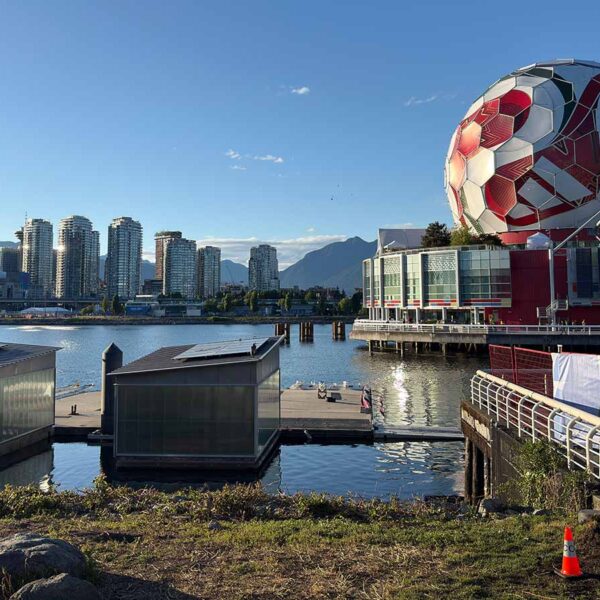 View of Vancouver skyline featuring Science World and a giant soccer ball at sunset.
