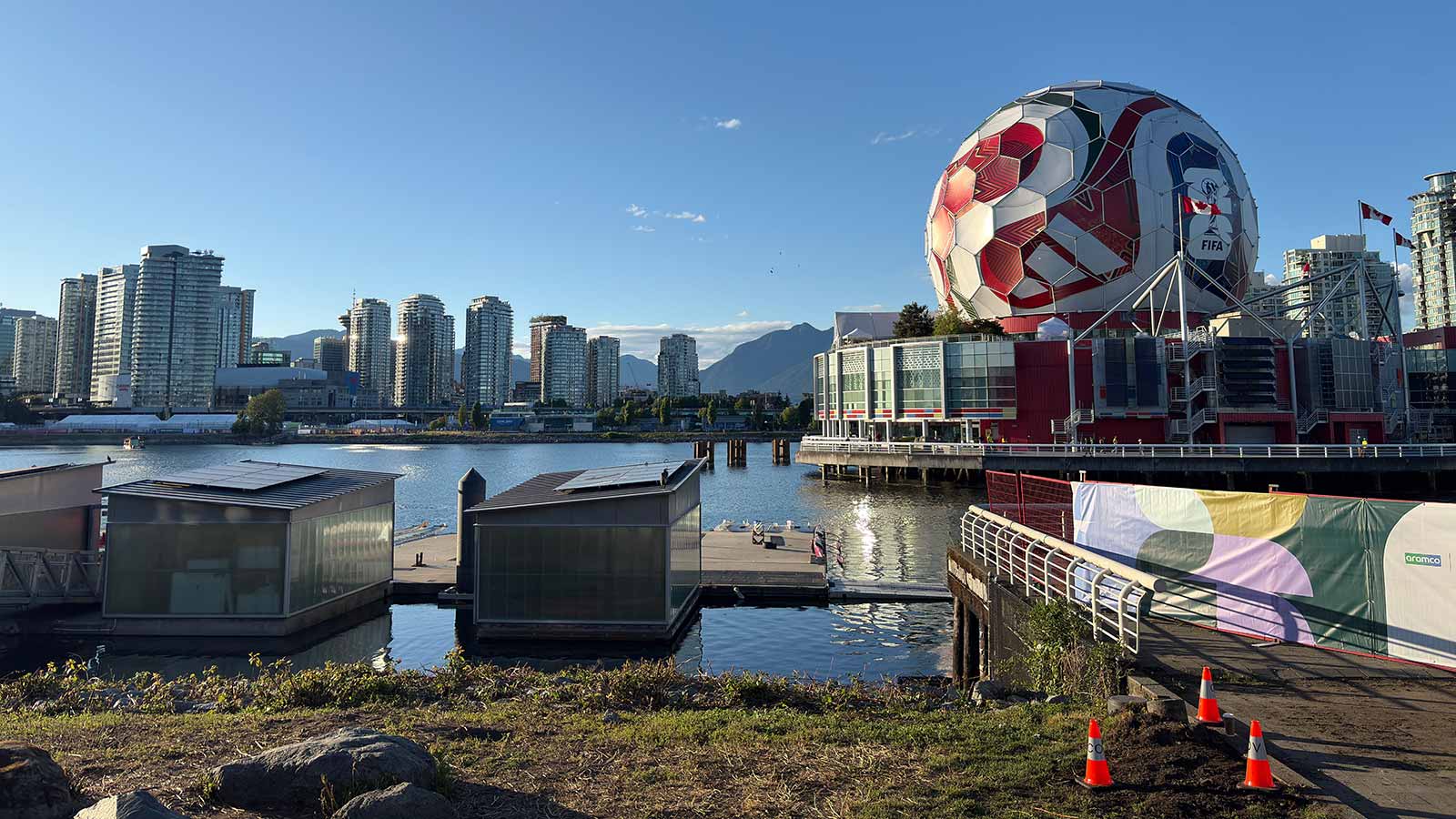 View of Vancouver skyline featuring Science World and a giant soccer ball at sunset.