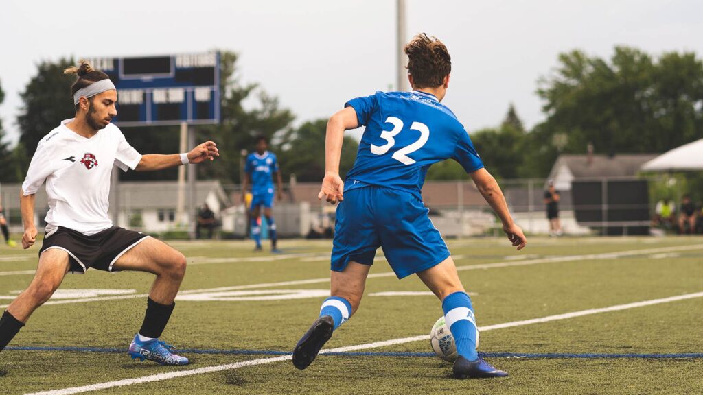 Players compete during a community pickup soccer match, an example of grassroots soccer in Canada.