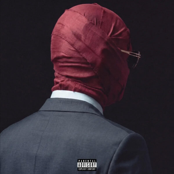 Man in suit wearing burgundy face covering, viewed from behind, representing the artwork for the new Tory Lanez album Made You Think I Was Gone ...But.
