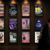 Mike Mikkelsen, known as Kapacity Mikey, in front of framed concert posters from his Ottawa hip-hop career.