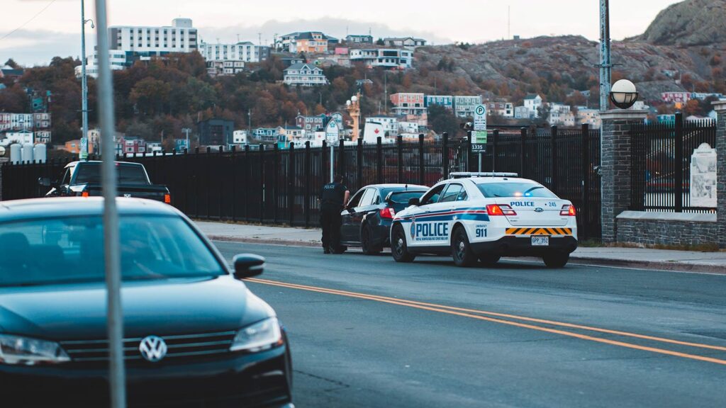 Police officer conducting a traffic stop as concerns grow over AI-powered policing and its impact on public trust.