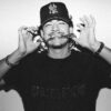 Ottawa rapper Taz Bentii bites the chain hanging around his neck.