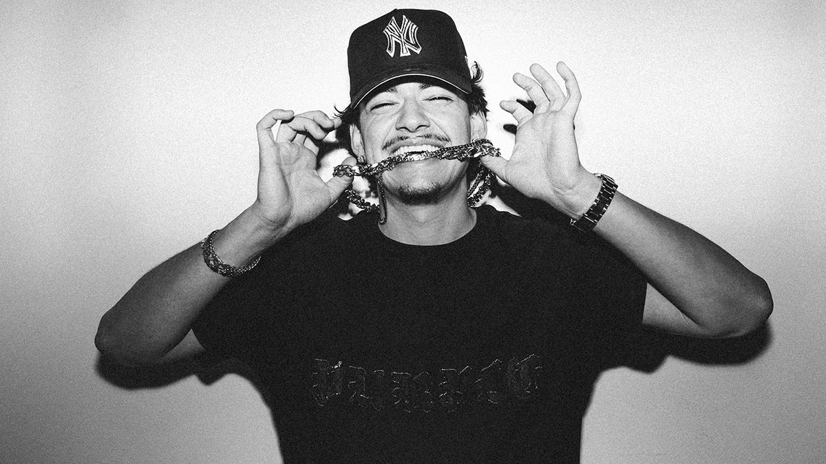 Ottawa rapper Taz Bentii bites the chain hanging around his neck.