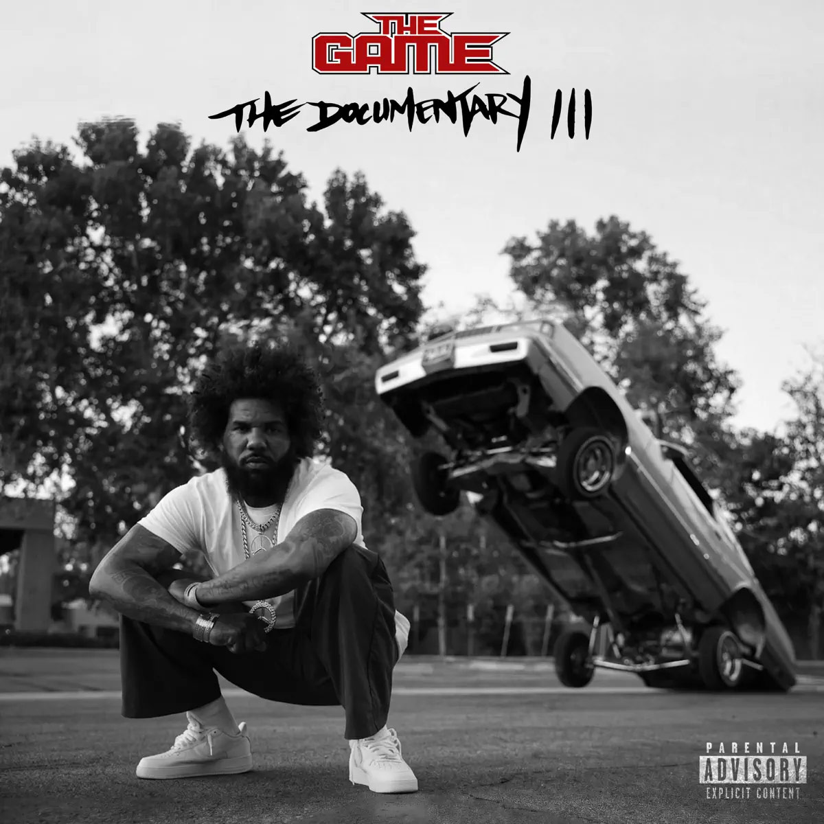 Rapper The Game crouches in front of a hydraulic lowrider on the artwork for his new album The Documentary III.