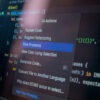 AI in the workplace shown through a software developer using an AI coding assistant to analyze and troubleshoot code.